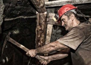 Man mining with a red hat.