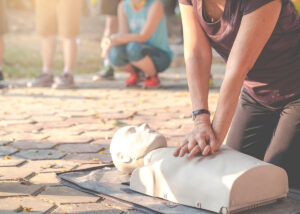 A woman learning to perform CPR.