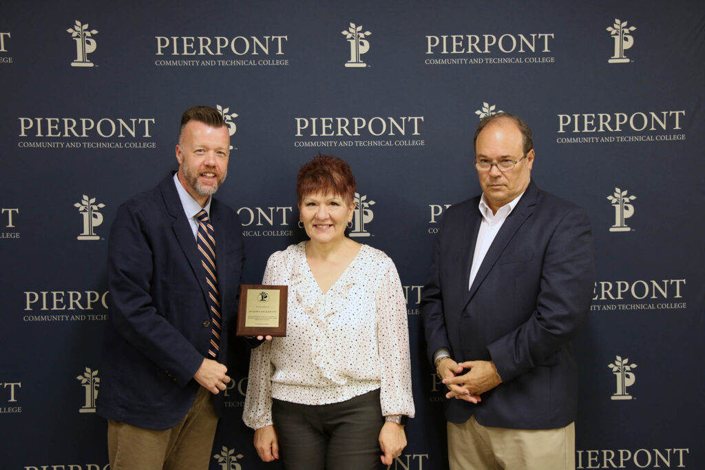 Juanita Nickerson receives a plaque from Dr. Michael Waide, Interim President, and David Hinkle, Board of Governors Chair
