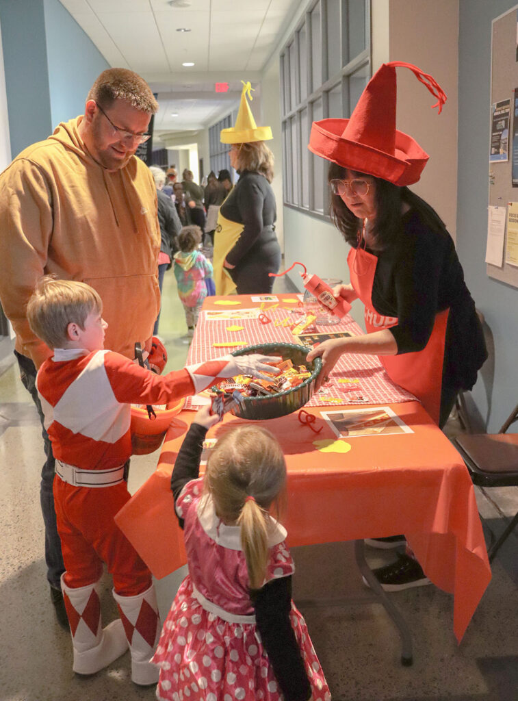 Children visit the School of Health Sciences’ ketchup-and-mustard-themed table during Pierpont Community and Technical College’s Community Trick-or-Treat event.