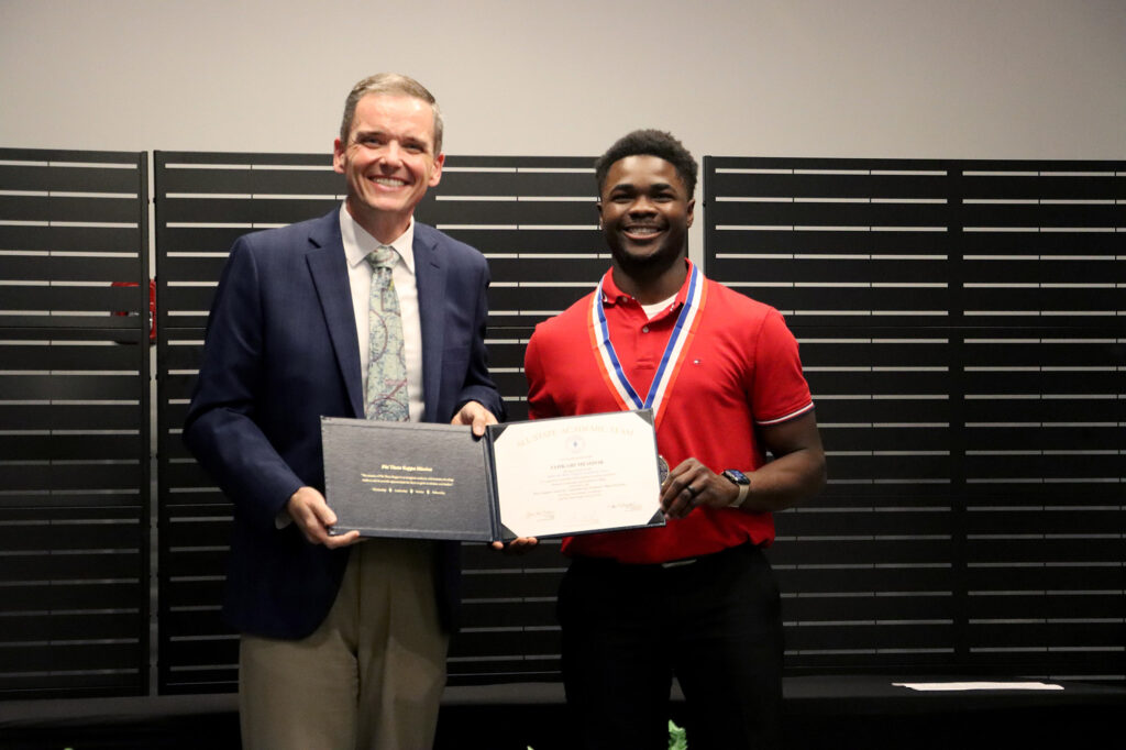 Jahkari Mesidor, an Aviation Maintenance Technology student at Pierpont Community & Technical College, receives special recognition as a Phi Theta Kappa All‑West Virginia Academic Team honoree from Dr. Chris Treadway, vice chancellor for the West Virginia Community and Technical College System. Mesidor is one of only four students selected statewide.