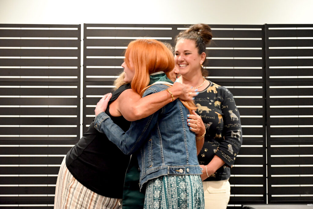 Anna Romano, Assistant Professor and Program Coordinator of Pierpont’s Veterinary Technology program, hugs a student during the 2026 Health Sciences Pinning Ceremony, celebrating the student’s transition into professional practice.