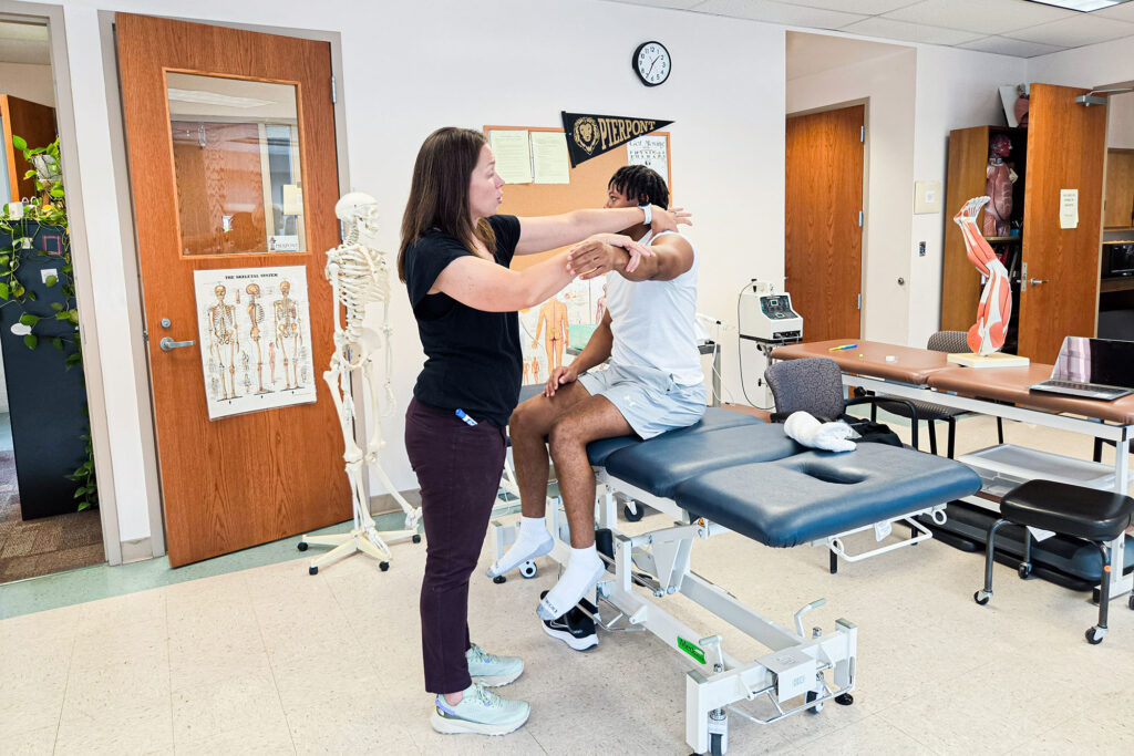 Pierpont Photo. Dr. Andrea Wamsley-Barr, program director and assistant professor of Physical Therapist Assistant, instructs a student during a lab session in Pierpont Community & Technical College's Physical Therapist Assistant program.