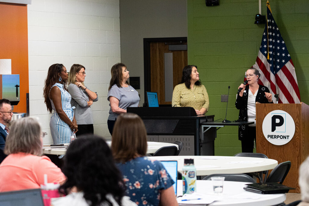 Pierpont Photo. From left, Memori Dobbs, director of student success; Jennifer McConnell, executive director of admissions, recruiting and student engagement; Amy Cunningham, dean of the School of Health Sciences; Jennifer Ellison, dean of the School of General Education and Professional Studies; and Kari Coffindaffer, dean of the School of Business, Aviation and Technology, discuss Pierpont's student persistence initiative during Professional Development Week All Call Day. The college-wide effort focuses on improving student success, persistence and completion.