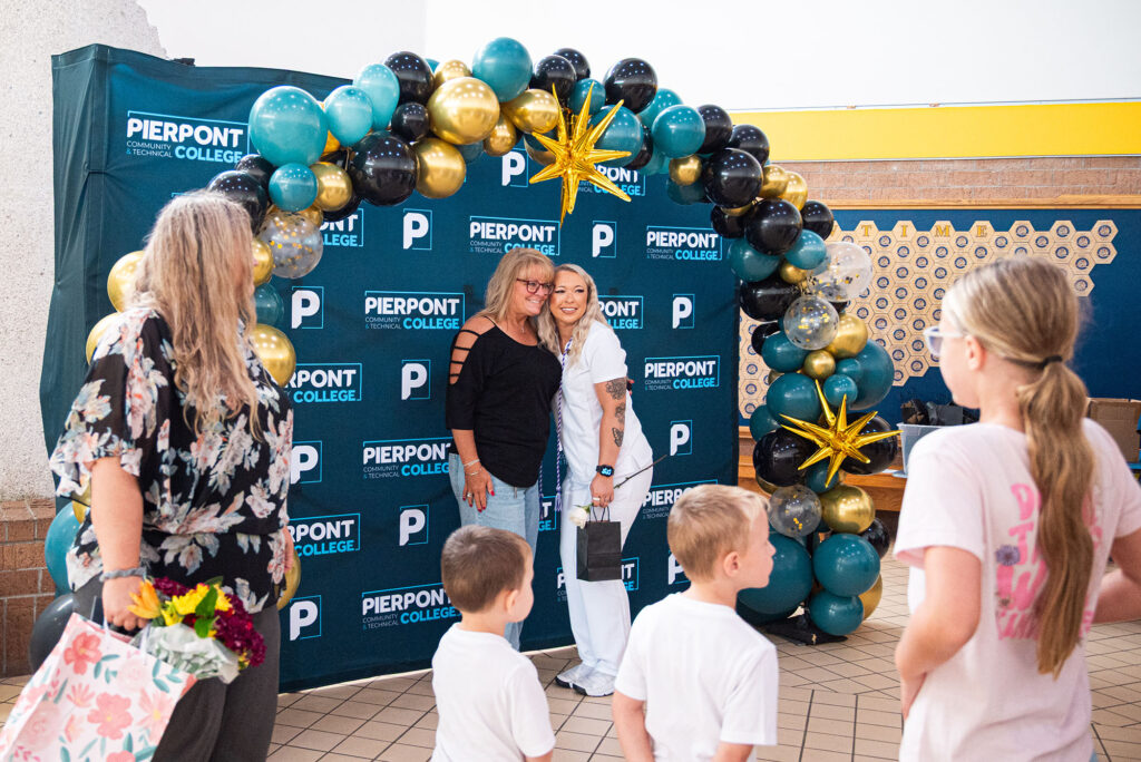 Family members and graduates gather for photos following Pierpont Community & Technical College's Licensed Practical Nursing Pinning Ceremony.