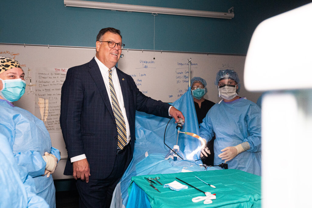 West Virginia Sen. Michael A. Oliverio II participates in a Surgical Technology demonstration with Pierpont Community & Technical College students on Monday.