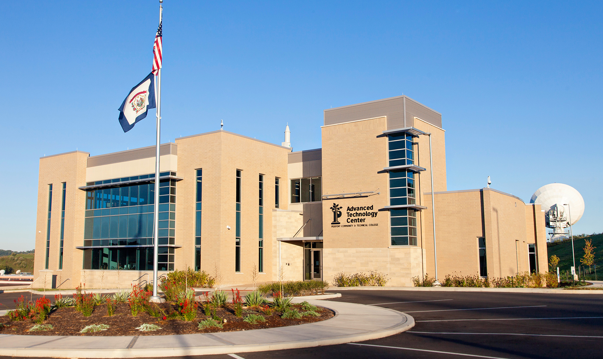 Image of Advanced Technology Center. Brick building with American and West Virginia flags flying in front.