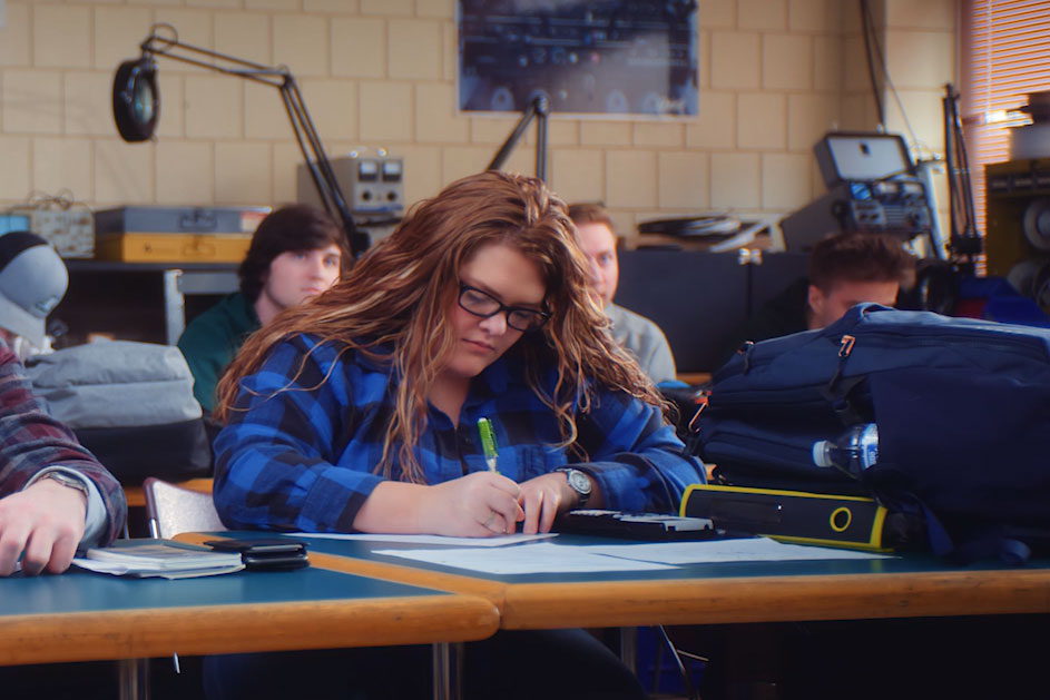 Student at desk taking notes