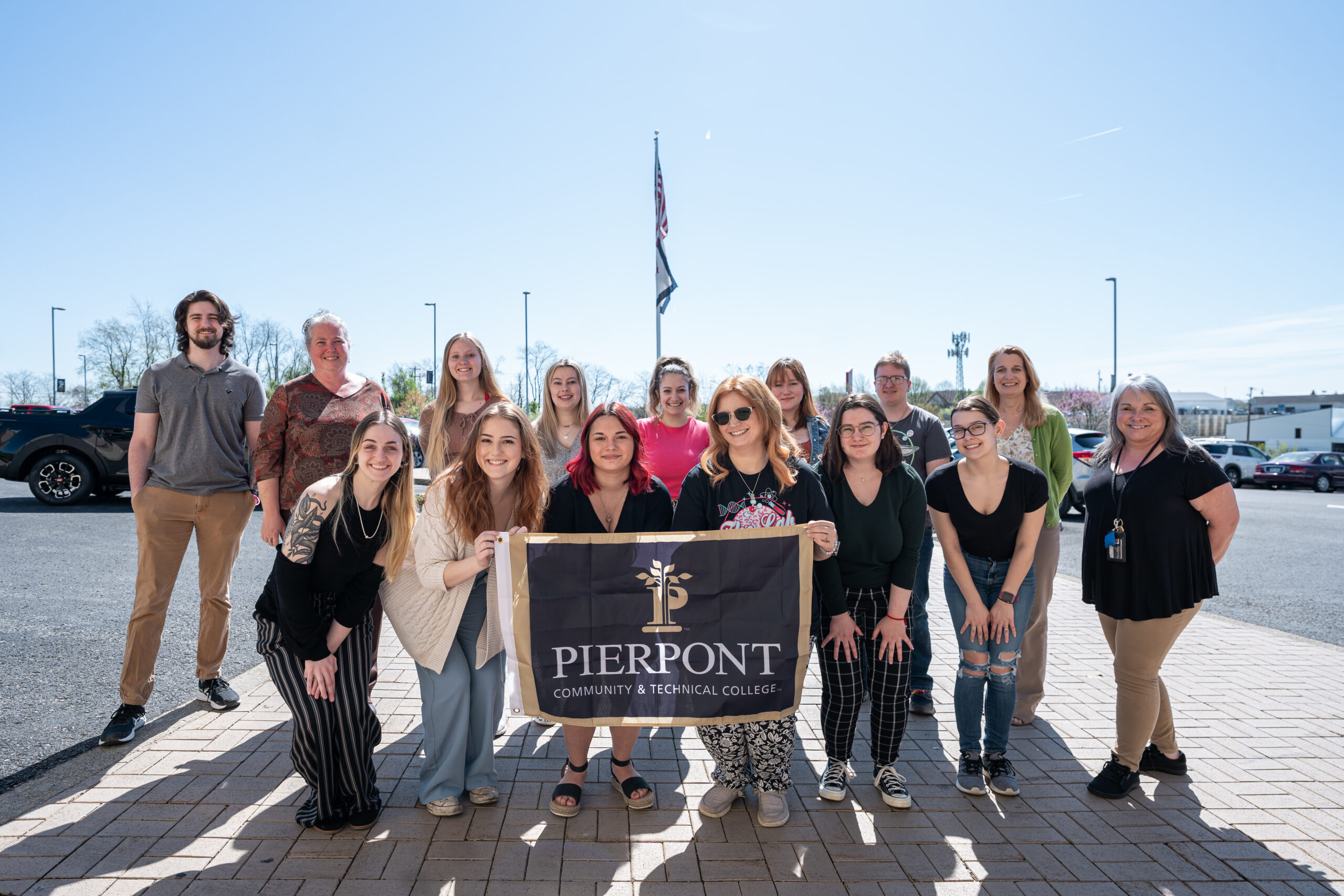 A group of students in the medical laboratory technology program are featured with a Pierpont flag.
