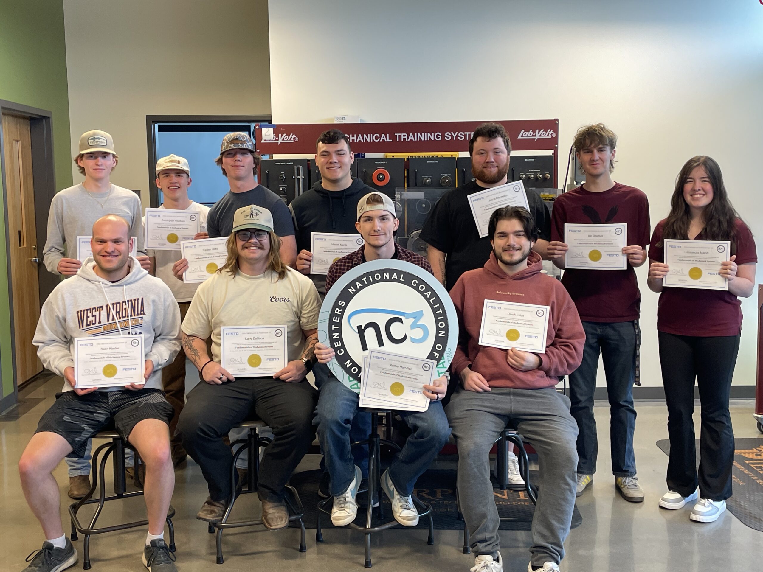 Students holding certificates of completion.
