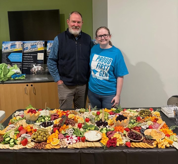 David Beighley, Interim Provost and Vice President of Academic Affairs, and Olivia Boltz, Director of Institutional Effectiveness and co-staff advisor of the First-Generation Student Organization, stand behind a charcuterie display by Country Roads Charcuterie during Pierpont Community & Technical College’s First-Gen Proud Celebration on Nov. 6 at the Advanced Technology Center.