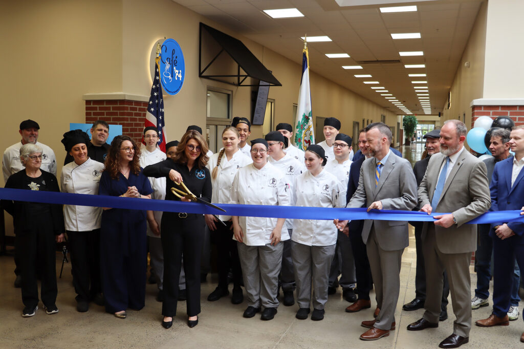 Food Service Management students stand alongside Pierpont Community & Technical College leaders and community partners as Natalie Feltz cuts the ribbon to mark the official opening of student‑run Café ’74 at Middletown Commons.