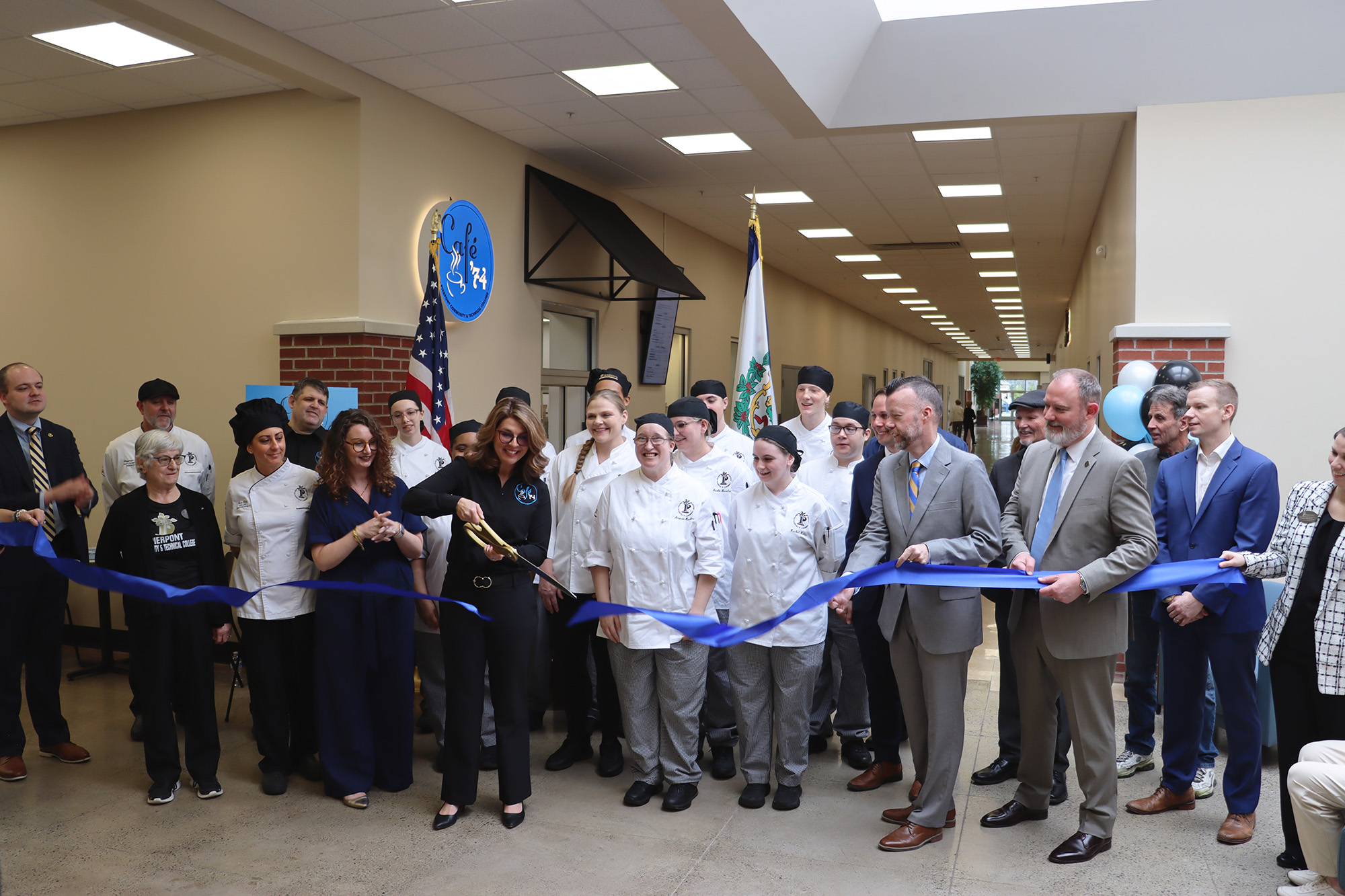 Food Service Management students stand alongside Pierpont Community & Technical College leaders and community partners as Natalie Feltz cuts the ribbon to mark the official opening of student‑run Café ’74 at Middletown Commons.