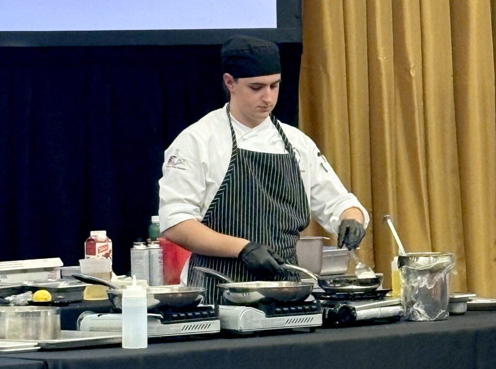Pierpont student Matthias Freeman prepares his entrée during the 3rd Annual WVU Culinary Competition at Nemacolin, where competitors had 45 minutes to complete their dishes.