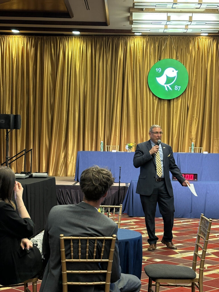 A competition official addresses attendees during the 3rd Annual WVU Culinary Competition at Nemacolin, which featured student chefs from colleges across West Virginia.