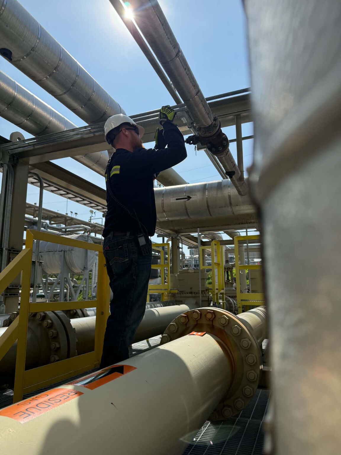 Applied Process Technology student inspects piping and equipment during an internship at an MPLX natural gas processing facility.