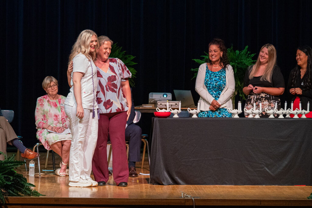 A graduate celebrates receiving a nursing pin during Pierpont Community & Technical College's Licensed Practical Nursing Pinning Ceremony, marking the transition from student to nursing professional.