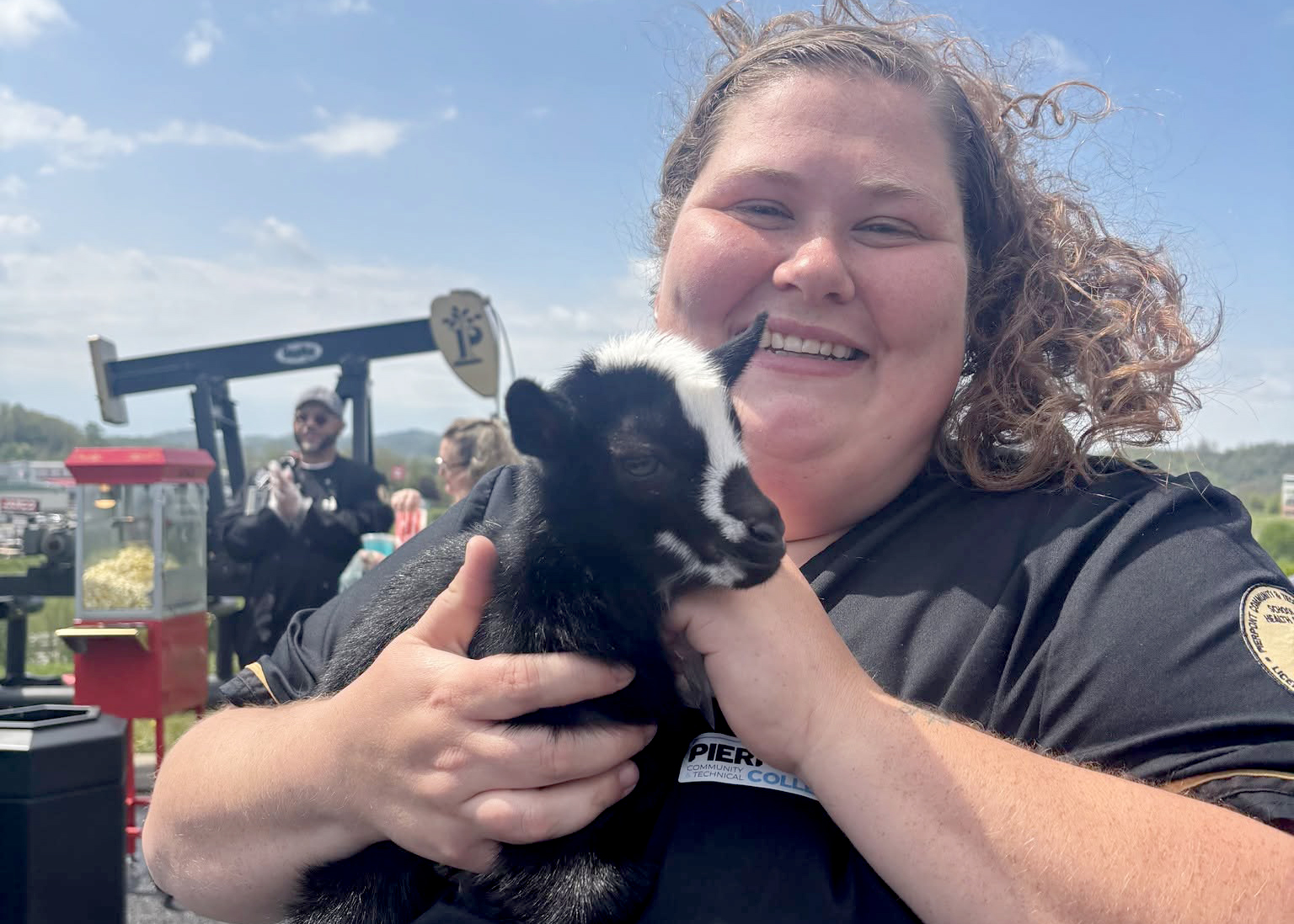 A Pierpont Community & Technical College student holds a baby goat during the Spring Farmers Market at the Advanced Technology Center in Fairmont. The event featured local vendors, agricultural exhibits and opportunities for community engagement.